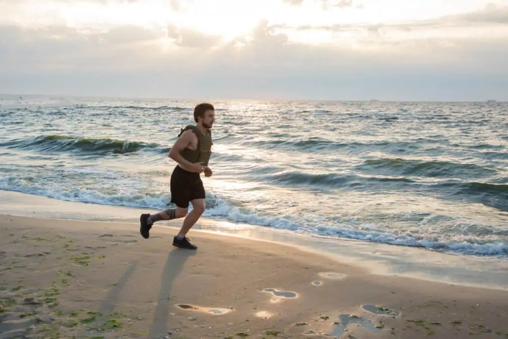 Running in weight vest on the beach