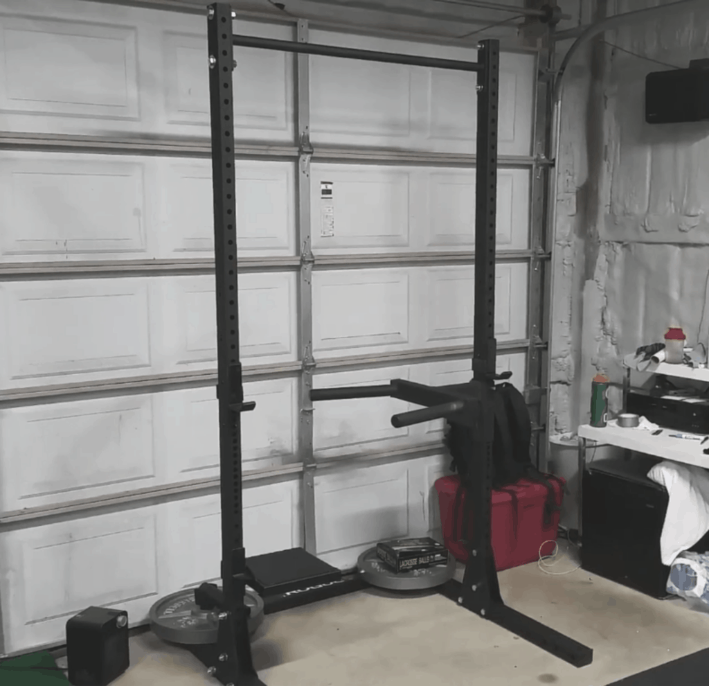squat rack attached with an adjustable dip bar