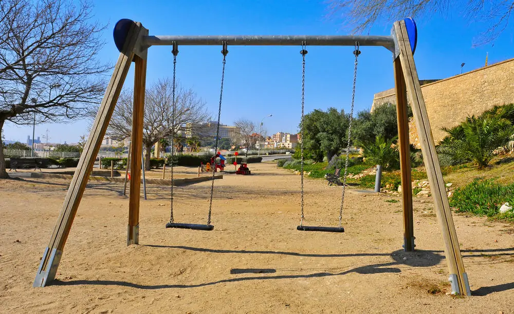 simple 4 legged playground swing in sand
